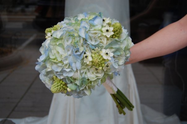 This photo shows a lovely hydrangea wedding bouquet designed by Monday 