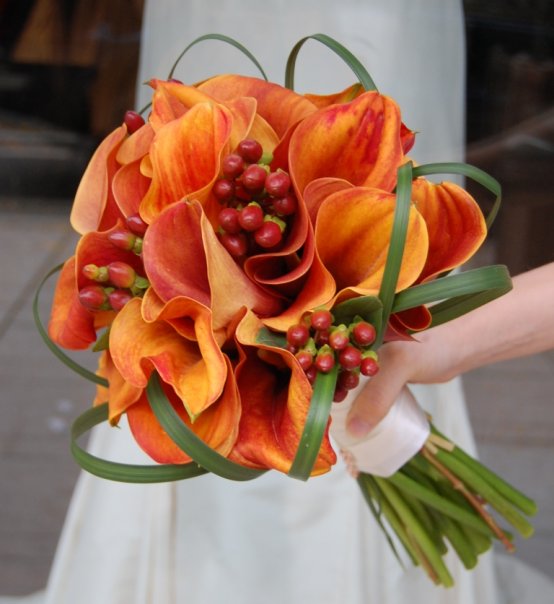 The flowers in this photo form a lovely orange calla lily wedding bouquet 