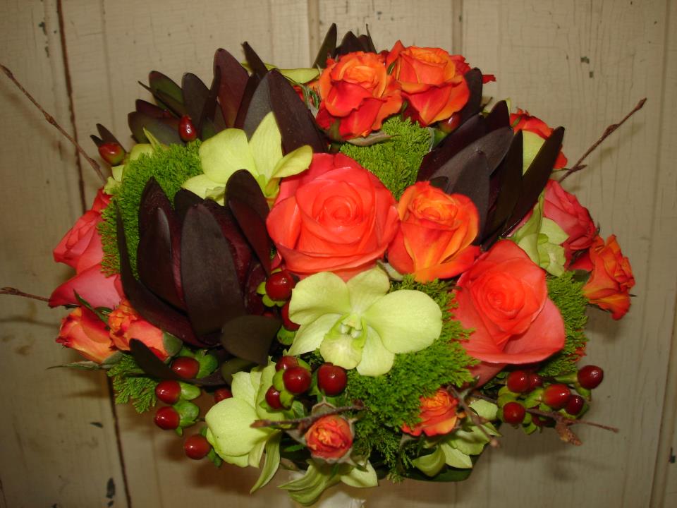This bouquet also includes honeycolored chrysanthemums and rustic red sedum 