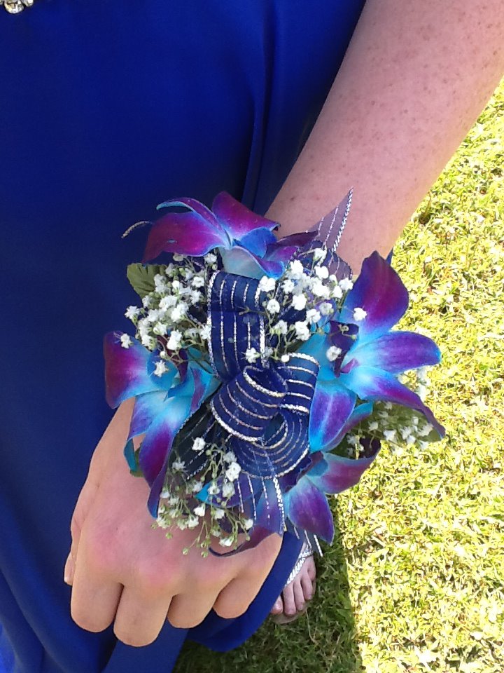 Purple orchid corsage by Devine Designs , Fulton NY