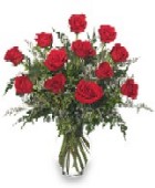 Photo of Dozen Red Roses arranged in a vase.