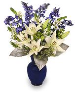 Hannukkah Flower Arrangment with blue delphinium, white lilies and blue vase