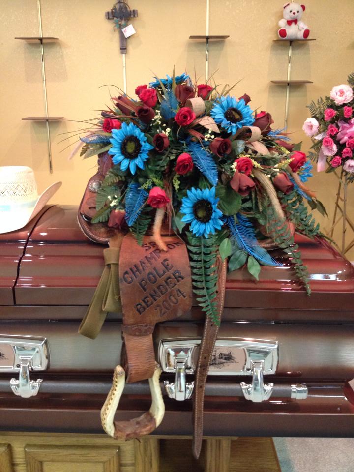 Beautiful casket spray design on a saddle from Personal Touch Floral & Gifts in Atoka, OK